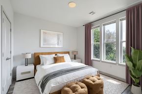 Baltimore apartment for rent - A bedroom with a large bed and a painting on the wall.