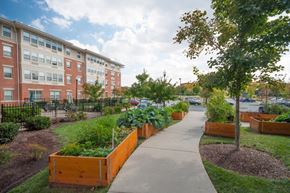 Baltimore apartment for rent - a sidewalk with a garden in front of a building
