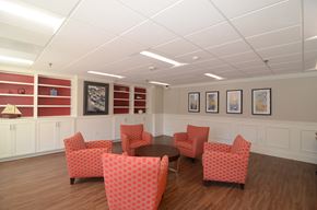 Annapolis apartment for rent - a waiting room with red chairs and paintings on the wall