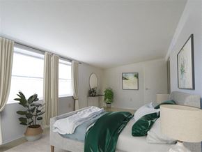 Baltimore apartment for rent - a bedroom with a bed and two windows