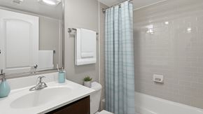 Lexington Park apartment for rent - A white bathroom with a blue vase on the sink.