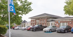 Edgewood townhouse for rent - A parking lot with cars and a building in the background.