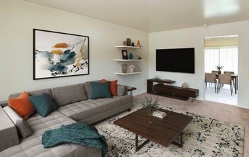 Edgewood townhouse for rent - A living room with a grey couch, a coffee table, and a painting on the wall.