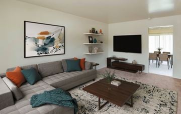 Edgewood townhouse for rent - A living room with a grey couch, a coffee table, and a painting on the wall.
