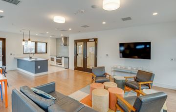 Washington apartment for rent - a living room with couches and chairs and a kitchen with a television