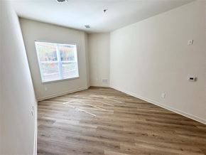 Silver Spring apartment for rent - A room with wooden flooring and a window overlooking a building.
