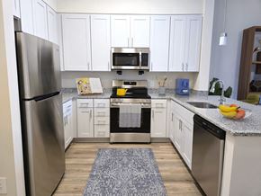 Silver Spring apartment for rent - A kitchen with white cabinets and a stainless steel refrigerator.