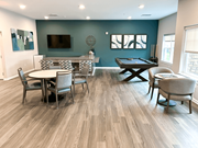 Frederick apartment for rent - a clubhouse with a pool table and chairs and a tv