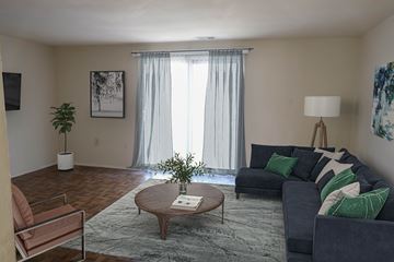 Baltimore apartment for rent - a living room with a blue couch and a coffee table