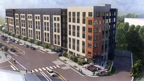 Rockville apartment for rent - A modern building with a parking lot in front of it.