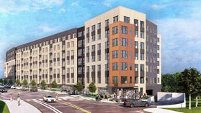 Rockville apartment for rent - A large building with a parking lot in front of it.
