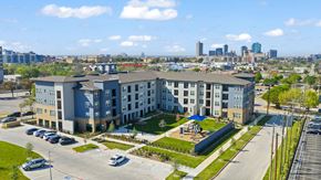 Fort Worth apartment for rent - A large apartment complex with a parking lot in front.
