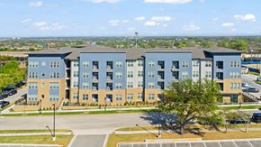 Fort Worth apartment for rent - A large apartment complex with multiple buildings and a parking lot in front.
