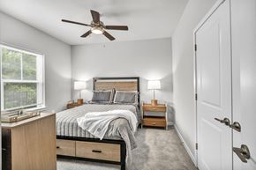 Charlotte apartment for rent - a bedroom with a bed and a ceiling fan