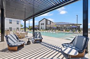 Converse apartment for rent - Pool at The Esther apartments in Converse, TX with tanning deck, lounge seating and umbrellas.