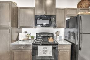 Austin apartment for rent - a kitchen with stainless steel appliances and granite counter tops