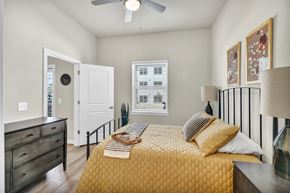 Austin apartment for rent - a bedroom with a bed and a ceiling fan
