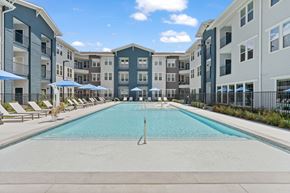 Schertz apartment for rent - Pool at Aviator 1518 apartments in Schertz, TX with tanning deck, lounge seating and umbrellas.