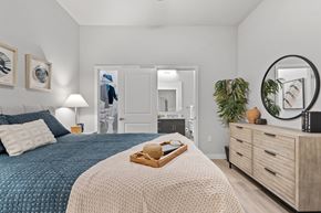 Houston apartment for rent - Contemporary apartment bedroom suite featuring coordinated furnishings, walk-in closet access, a private ensuite bathroom, and thoughtfully designed residential living spaces.