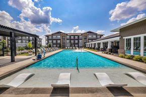 Von Ormy apartment for rent - a swimming pool with lounge chairs and a building in the background