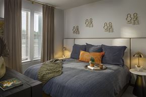 Princeton apartment for rent - A bedroom with a bed, nightstand, and wall decorations.