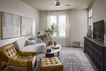 Princeton apartment for rent - A living room with a brown leather chair and ottoman.