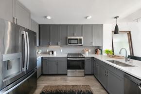 Jersey City apartment for rent - A modern kitchen with a stainless steel refrigerator and a microwave above the stove.