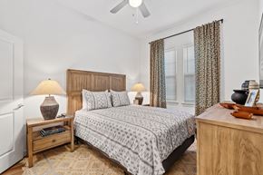Schertz apartment for rent - Bedroom at Aviator 1518 with bed, dresser and nightstands in an open floor plan layout.