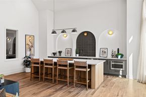 Mesquite apartment for rent - Resident clubhouse featuring bar-height seating, refreshment station, and open gathering space for socializing and community events.