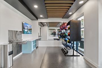 Fort Worth apartment for rent - A modern kitchen with a long counter and a stainless steel refrigerator.