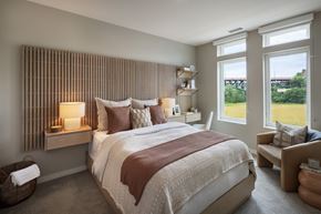 Cleveland apartment for rent - A bedroom with a large bed and a window overlooking a green landscape.