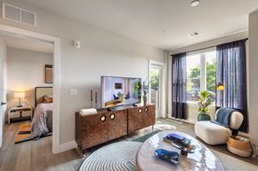 Jersey City apartment for rent - A modern living room with a wooden cabinet and a tv.