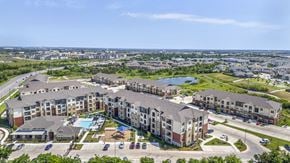 Austin apartment for rent - an aerial view of an apartment complex with a pool and parking lot