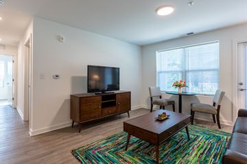 Evansville apartment for rent - A living room with a wooden coffee table and a television on a cabinet.