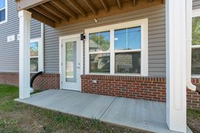 Evansville apartment for rent - Private exterior entry with covered patio space, large windows, and a glass door, offering a welcoming and functional outdoor area.