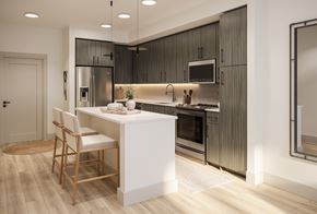 Charlotte apartment for rent - A modern kitchen with a white island and wooden flooring.