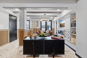 San Antonio apartment for rent - A black and white kitchen with a black fridge and a black table with a bowl of fruit on it.