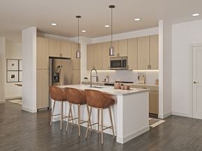 Del Valle apartment for rent - A modern kitchen with a white island and brown bar stools.