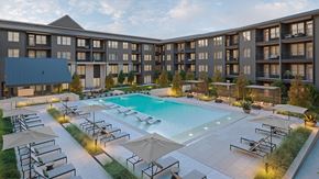 Del Valle apartment for rent - A large hotel with a pool in the foreground.