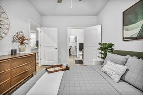 San Antonio apartment for rent - A bedroom with a large bed and a wooden dresser.