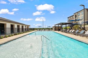 San Marcos apartment for rent - Community pool featuring a tanning ledge, lounge seating, and shaded relaxation areas.