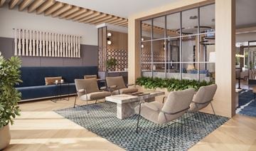 Anna apartment for rent - A modern living room with a blue sofa and wooden furniture.