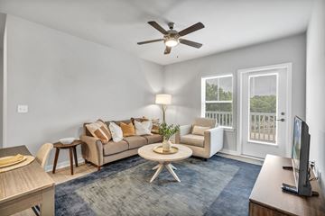 Charlotte apartment for rent - a living room with a couch and a ceiling fan