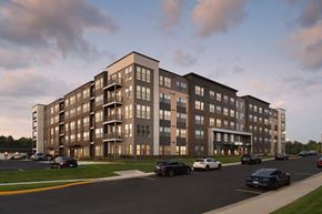 Woodbridge apartment for rent - A large apartment building with cars parked in front.