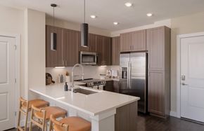 Venice apartment for rent - A modern kitchen with a white countertop and brown cabinets.