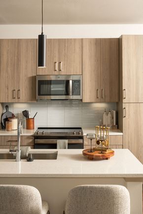 Sanford apartment for rent - A modern kitchen with wooden cabinets and a white countertop.