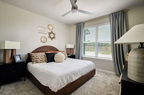 Dallas apartment for rent - a bedroom with a large bed and a ceiling fan