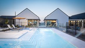 Dallas apartment for rent - a swimming pool in front of a pool house with a water fountain