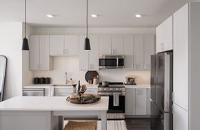 Hyattsville apartment for rent - A modern kitchen with white cabinets and a central island.
