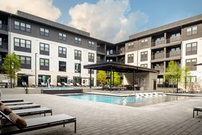 Austin townhouse for rent - A large apartment complex with a pool in the courtyard.